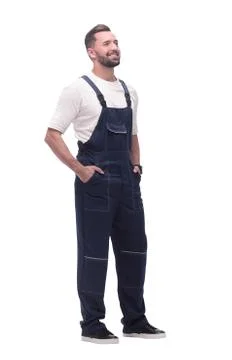 Side view. smiling man in overalls looking forward to copy space Stock Photos