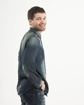 Side view of smiling stylish young guy is looking forward to the Stock Photos