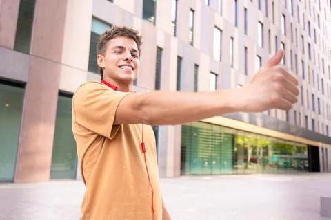 Side view Smiling Young Man Giving a Thumbs-Up Outdoors Stock Photos