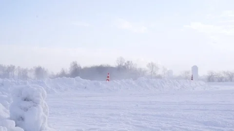 Side view of a snowy racing track in winter on blue sky background. Footage. Stockbeeldmateriaal 126765645