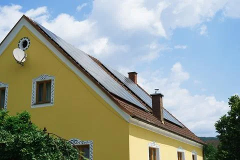 Side view of solar panels installed on the roof of a private house Stock Photos
