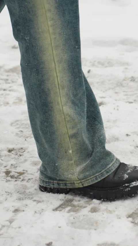 Side View of Someone Walking in Snow with Black Boots Stock Footage 317887078