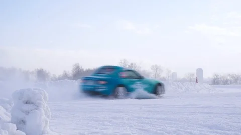Side view of a sport car going into a skid on snowy track in winter. Footage. Stock-Footage 126765647