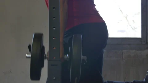 Side view sport man doing Bulgarian / Split squat in home gym. Dark shot. Stock Footage 142986172