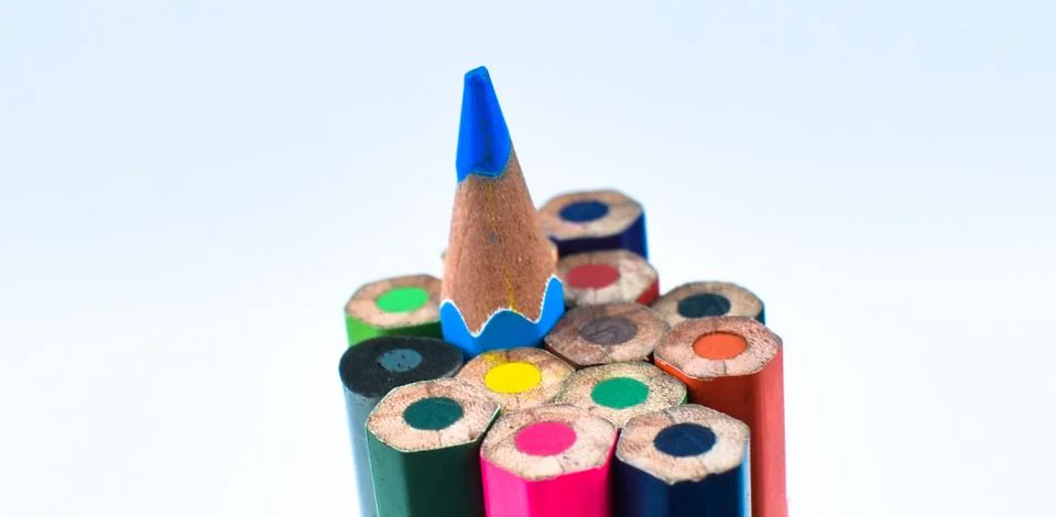 Side view of a stack of different color wood pencil crayons arranged together Stock Photos