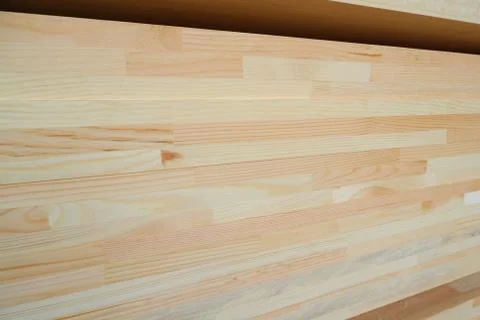 Side view of stack of three-layer wooden glued laminated timber beams from pi 스톡 사진