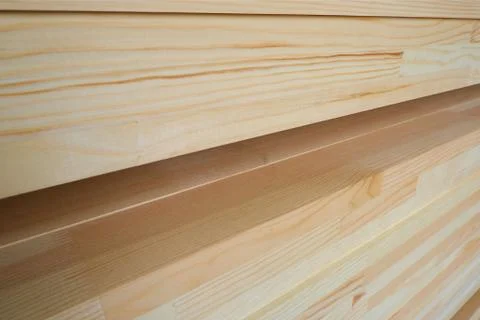 Side view of stack of three-layer wooden glued laminated timber beams 스톡 사진