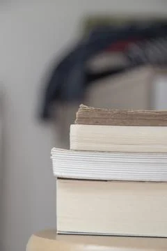 Side view of stacked books of different thicknesses Stock Photos