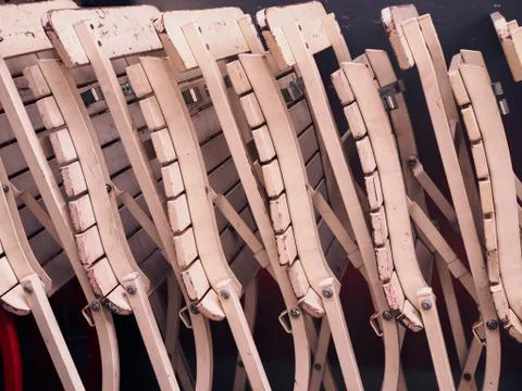Side view stacked old white wooden chair row 库存照片