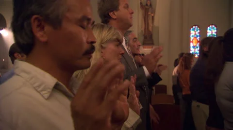 Side view of standing congregation reciting the Lord's Prayer Stock Footage 59250467