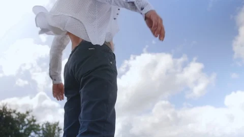 Side view of a standing man and spreading his arms against the background of Stock-Footage 113279876