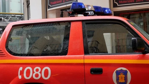 Side view static shot of a fireman red car parked outdoor on the street Stock Footage 120186536