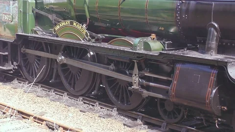 Side view steam engine leaving station Stock Footage 80287604