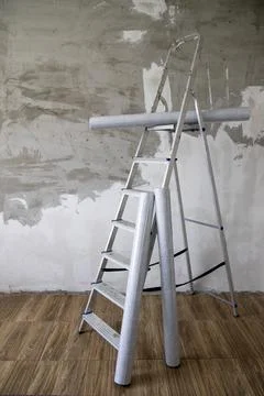Side view of a stepladder and rolls of non-woven Stock Photos