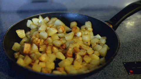 Side view of stove top and diced potatoes Stock-Footage 872353