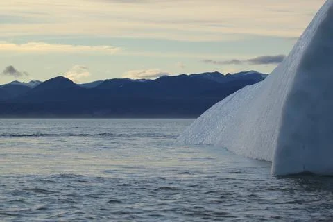 Side view of a stranded iceberg and ice near evening in arctic landscape, near Stock Photos