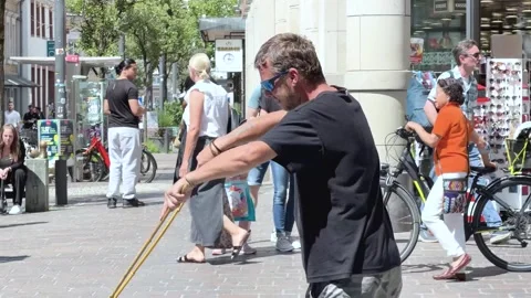 Side View of a Street Performer Making Giant Soap Bubbles Stock Footage 341437721