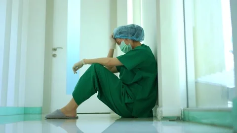 Side view of stressed and overworked female doctor medical worker surgeon sit Stock Footage 178448631