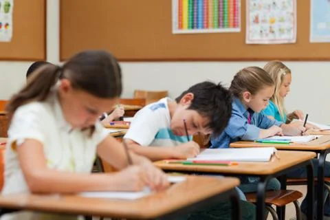 Side view of students doing exercises during class Stock Photos