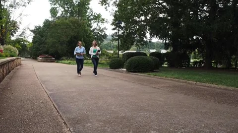 Side view of students walking down a sidewalk Stock Footage 55289099