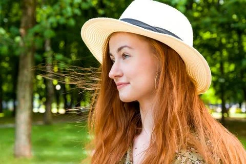 Side view summer portrait with happy smiling female wearing summer hat and dr Stock Photos