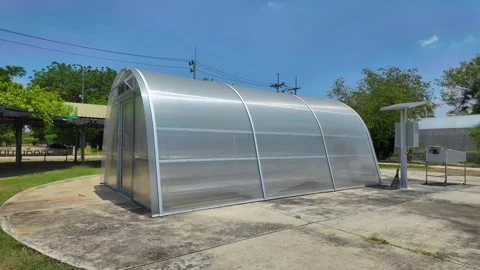 Side view of sun dryer glass house for dried fruit preservation Stock Footage 276339271