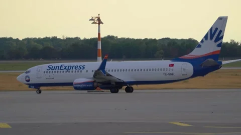 Side view of SunExpress passenger aircraft taxiing on the taxiway Stock Footage 247639459