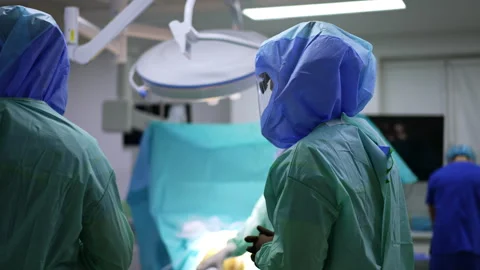 Side view of a surgeon in protective helmet  Stock Footage 241286175