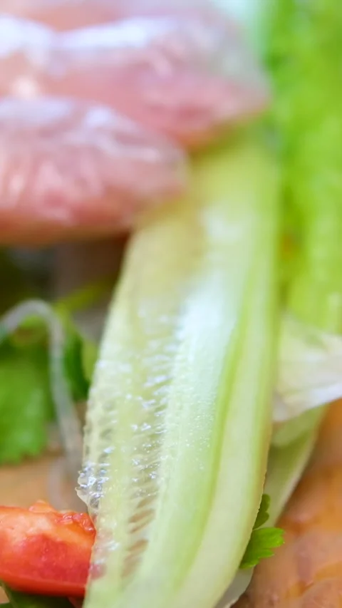 Side view of a sushi chef hands leveling triangle Japanese roll in rice paper Stock Footage 302731192