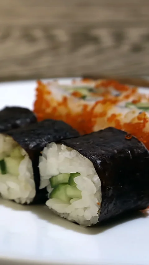 Side View Of Sushi Rolls On A White Plate Moving Left To Right Stock Footage 305383394