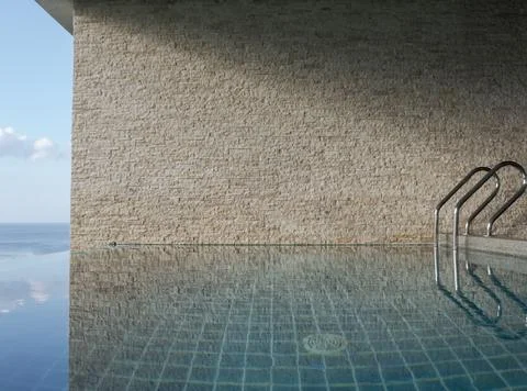 Side view of swiming pool handles near brick wall in hotel room. Stock Photos