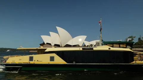 Side view Sydney Opera House and public ferry transport 6K Video stock 327574225