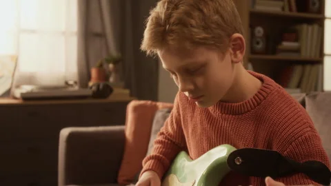 Side View of Talented Young Boy Playing Electric Guitar at Home Stock Footage 333426259