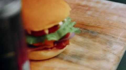 Side view of a tall decorated cheeseburger, 4K Stock Footage 341117618