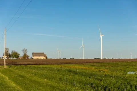 Side view of Tan Barn &amp; House in Wind Turbine Farm Stock Photos