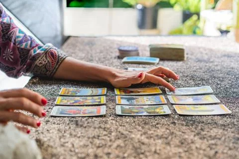 Side view of a tarot reader's hands reading the cards Stock Photos