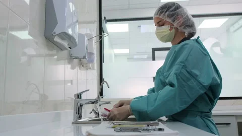 Side view of technician wash instruments. Disinfection of dental probe. Stock Footage 131683829