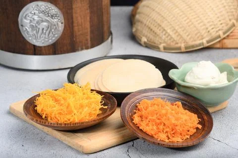 Side view of Thai crispy pancakes topped with strips of egg yolks on wood p.. Stock Photos