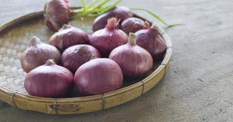 Side view, Thai red onion or Shallots. Fresh purple shallots on bamboo basket Stock Photos