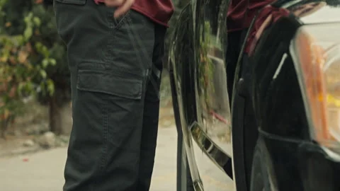 Side view of a Thief with a crowbar next to someone's car Stock Footage 283066211