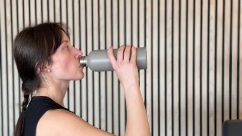 Side view of thirsty woman drinking water from bottle Stock-Footage 336271935
