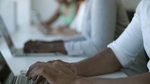 Side view of thoughtful man in eyeglasses typing on laptop Stock Footage 117366045