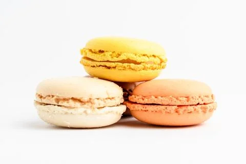 Side view of three sweet lemon, orange and vanilla French macaron Stock Photos