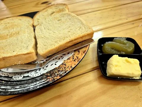 Side view of toasted bread served with butter and kaya spread Stock Photos