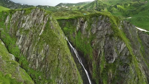 Side view of tourist with backpack walking hiking the mountain .waterfall on Stock Footage 310230372