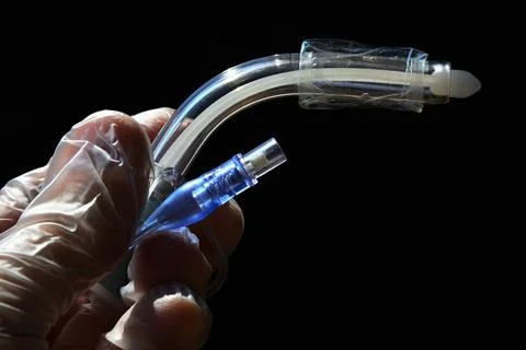 Side view of tracheostomy cannula with deflated cuff Stock Photos