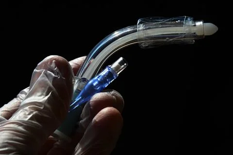 Side view of tracheostomy cannula with deflated cuff Stock Photos