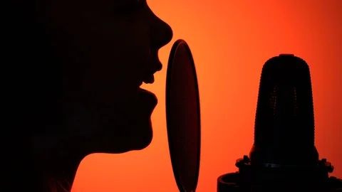 Side view tracking close-up shot of cute little girl silhouette singing with a Stock Footage 75183965
