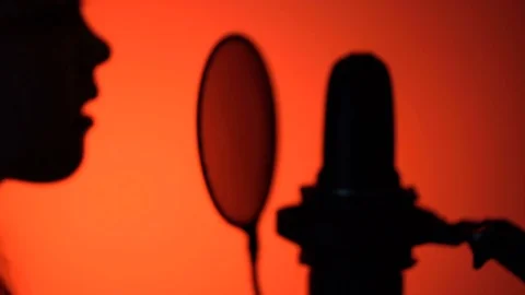 Side view tracking close-up shot of cute little girl silhouette singing with a Stock Footage 75198379