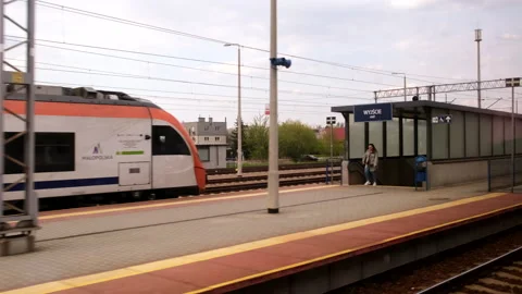 Side view from the train passing by railway station Stock Footage 194536041